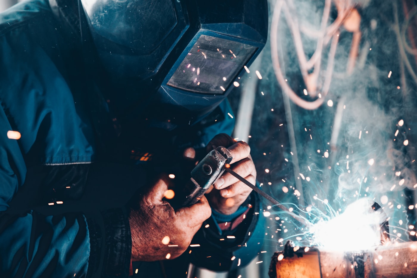 Steel being worked in a fabrication shop with dramatic lighting